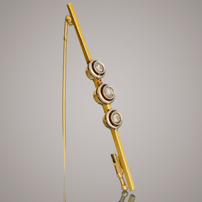 Alfiler en oro amarillo y oro blanco de 18kt con tres brillantes talla antigua.