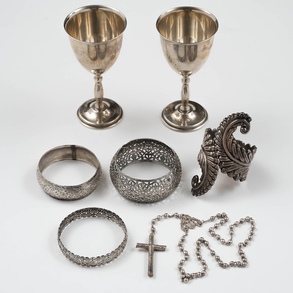 Conjunto de dos copas, brazalete, tres pulseras caladas y rosario en plata del siglo XX
