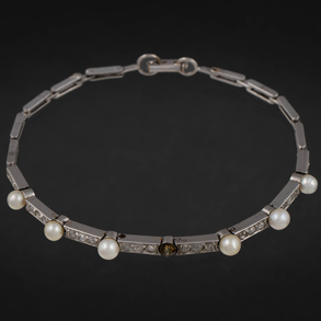 Pulsera articulada en oro blanco de 18 kt con perlitas.
