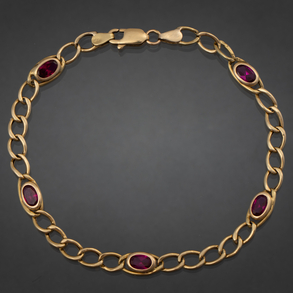Pulsera en oro amarillo de 18 kt con piedras sintéticas de color rojo.
